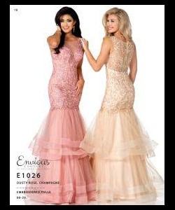 Two women wearing floor-length, sleeveless mermaid gowns in pink and champagne with lace and tulle details.